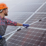 male-worker-cleaning-solar-panels